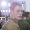 Male Aveda model with red hair looking at the camera