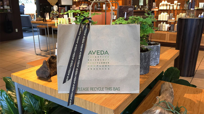 An Aveda gift bag on a table