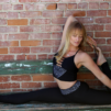 Woman in black yoga outfit in a inverted scorpion pose