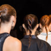 A line of Aveda models with the same twisted hair style