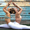 Two woman in pastel colors doing Yoga