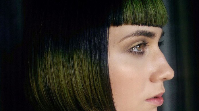 aveda hair color - woman with sharp cut and green tones
