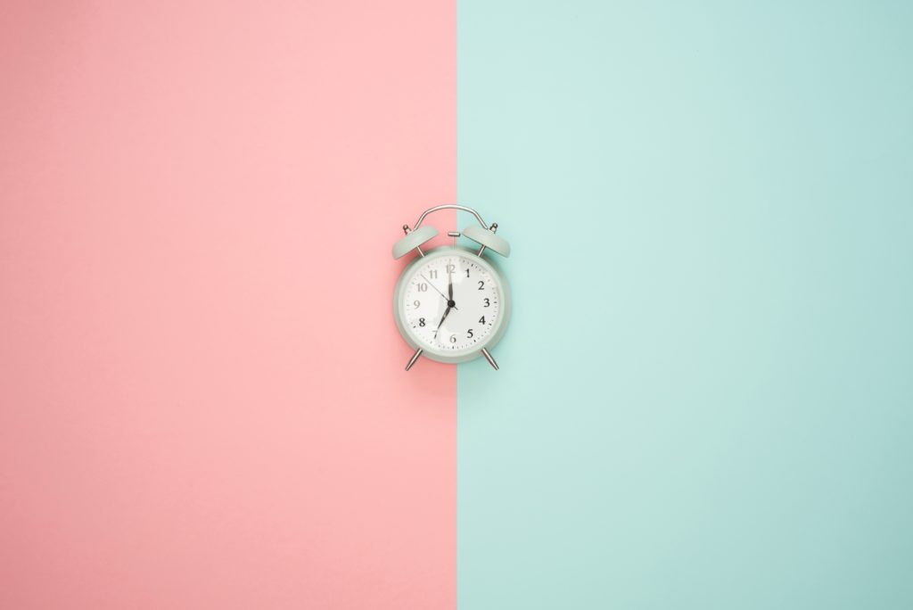 clock on pink and blue background