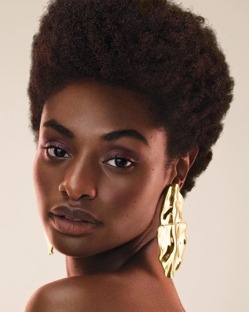 Woman with textured hair and elaborate earrings