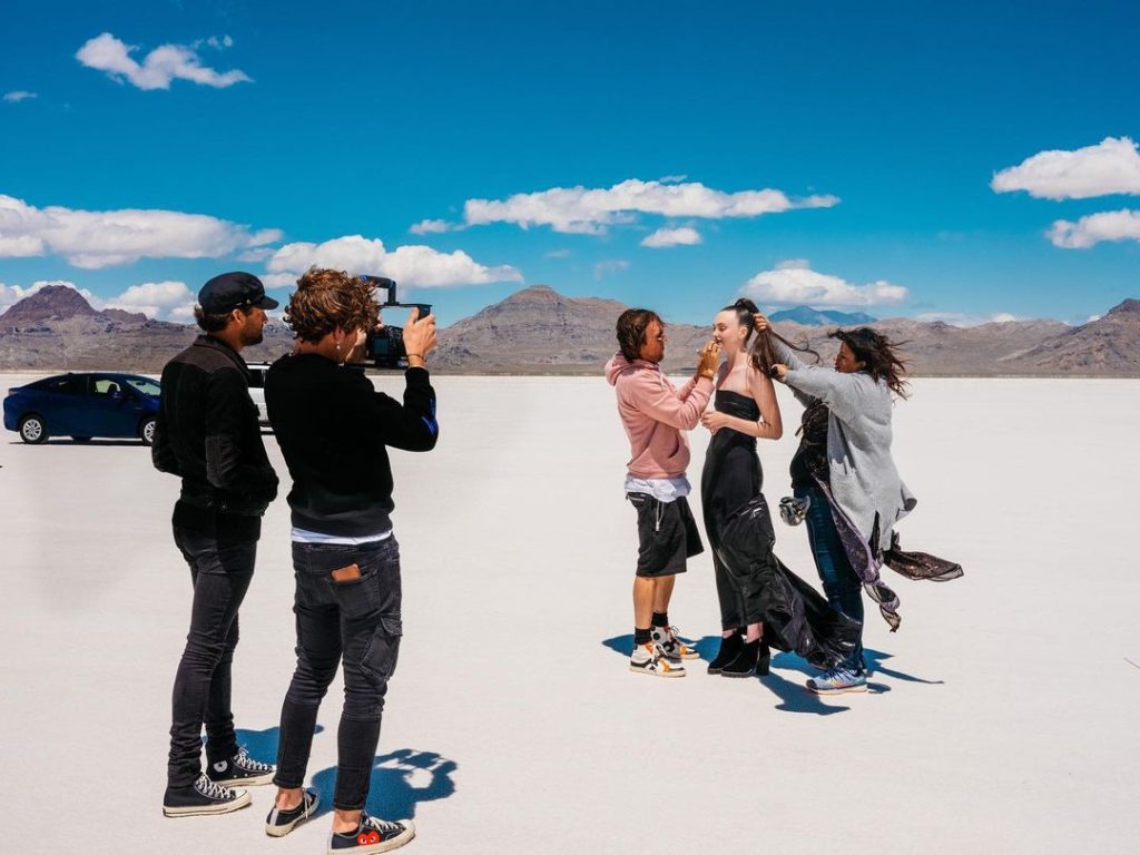 Beauty influencer making video in desert with crew